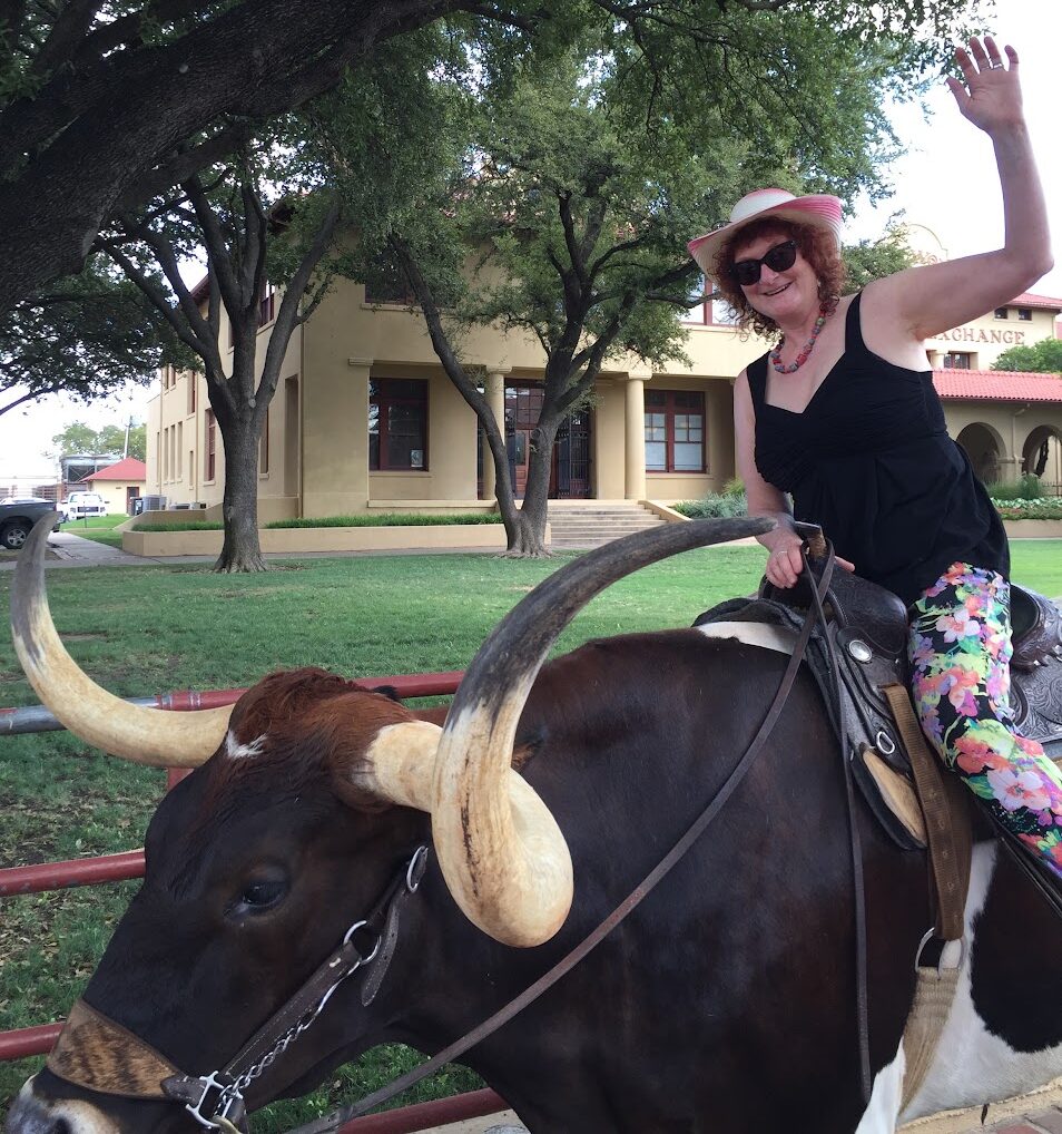 Laura Donefer in texas riding a long horn