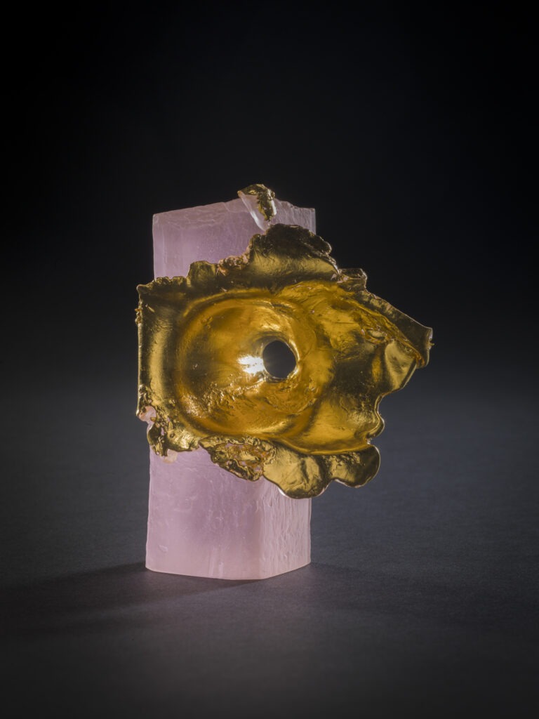 a pink and gold glass sculpture