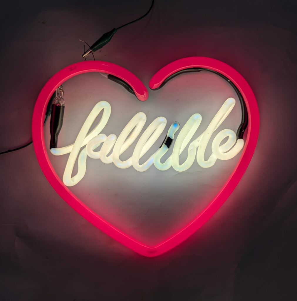 neon lettering in a red neon heart